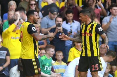 WATFORD, ENGLAND - SEPTEMBER 02:  Troy Deeney of Watford (9) celebrates as he scores his team's first goal with Jose Holebas of Watford (25) during the Premier League match between Watford FC and Tottenham Hotspur at Vicarage Road on September 2, 2018 in Watford, United Kingdom.  (Photo by Mike Hewitt/Getty Images)