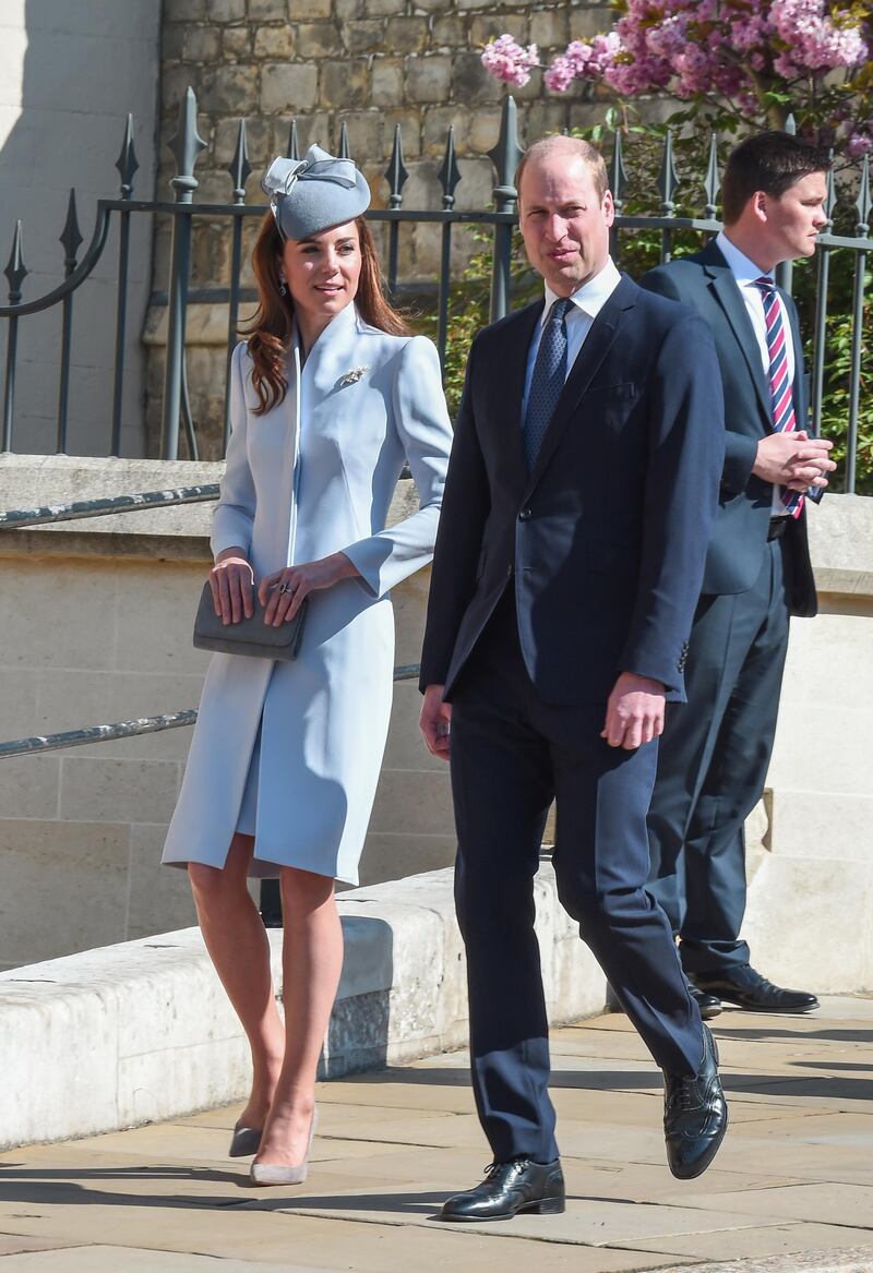 The Duchess of Cambridge wears a light blue tailored coat by Alexander McQueen, with a Jane Taylor hat,  Emmy London's Rebecca heels in Cinder, an Emmy London clutch, the Robinson Pelham she wore for her 2011 wedding to Prince William, and a gold and pearl acorn and oak leaf brooch for the Easter Sunday service at St George's Chapel on April 21. Getty Images
