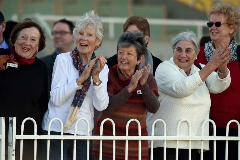 Spectators cheering at camel racing carnival.