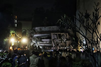 Rescue teams search for survivors in the debris of a residential building that collapsed in Lucknow on Tuesday.  AFP