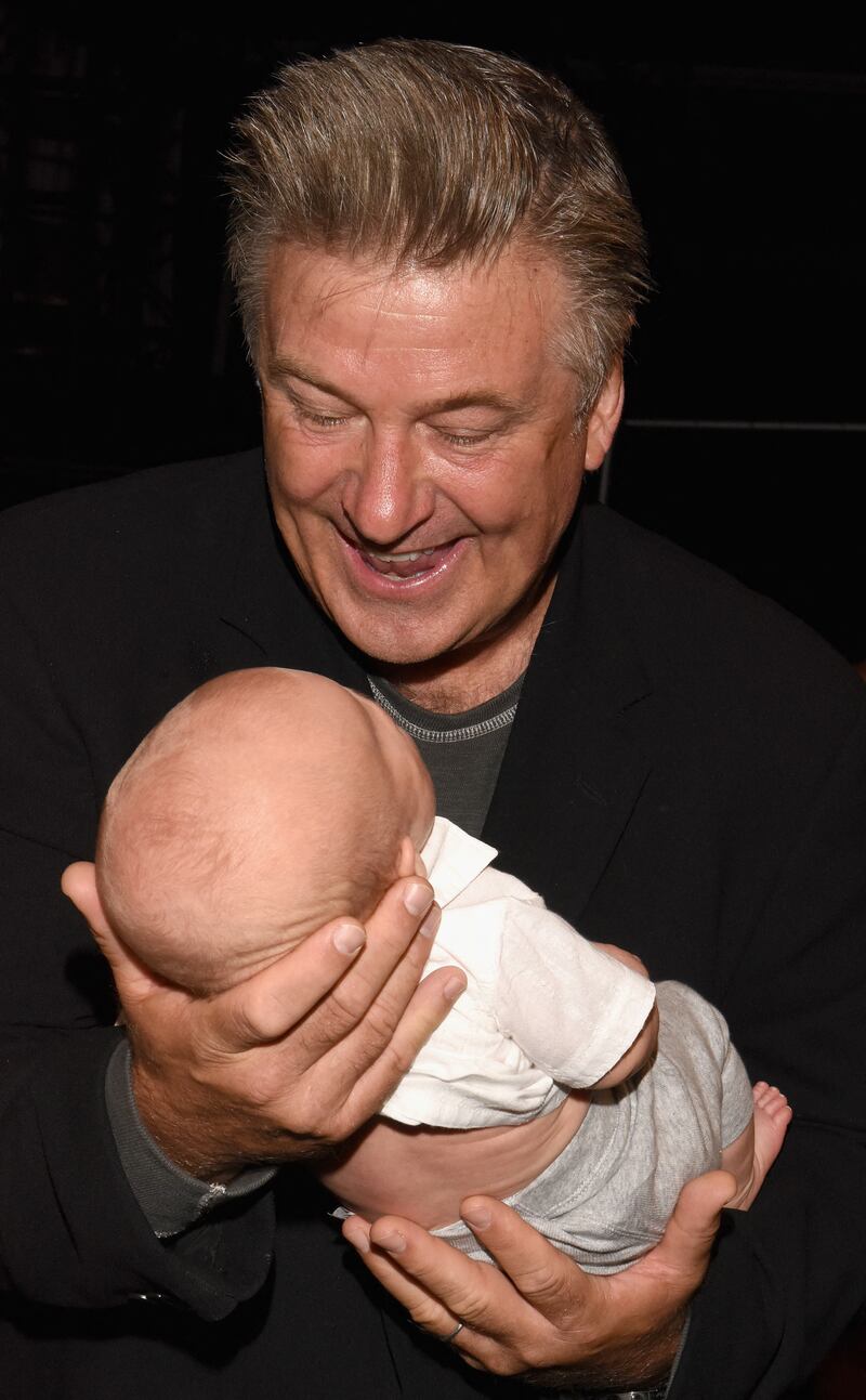 Alec Baldwin holds son Rafael Baldwin backstage at the Carmen Marc Valvo spring/summer 2016 show during New York Fashion Week, in September 2015. Getty