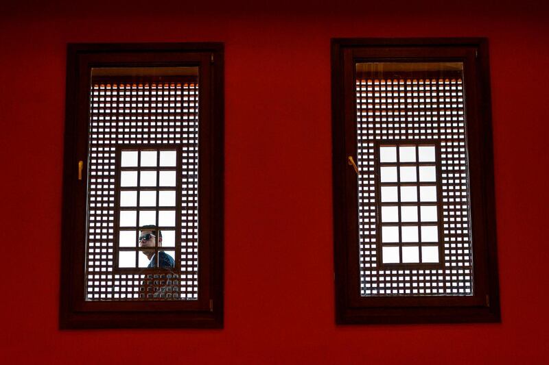 A security guard looks through a window at the American University Cairo, in Egypt. AFP