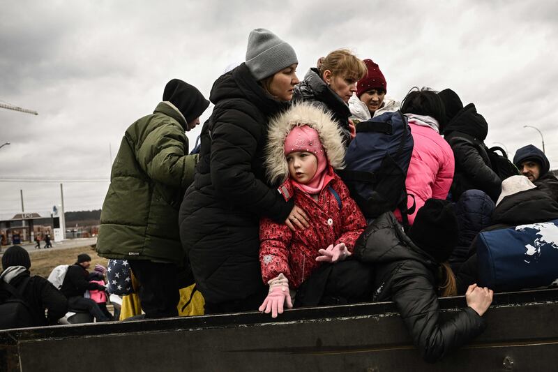 Residents flee from the city of Irpin, north-west of Kyiv, during heavy shelling and bombing on March 5, 2022. AFP