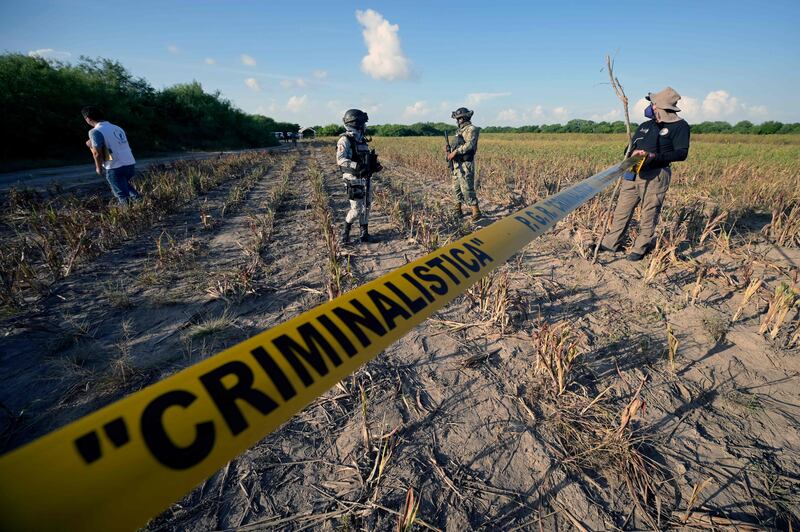 Matamoros has been racked by cartel violence in recent years. Here, Mexican law enforcement agents guard the entrance to an area where human remains are often found. AFP