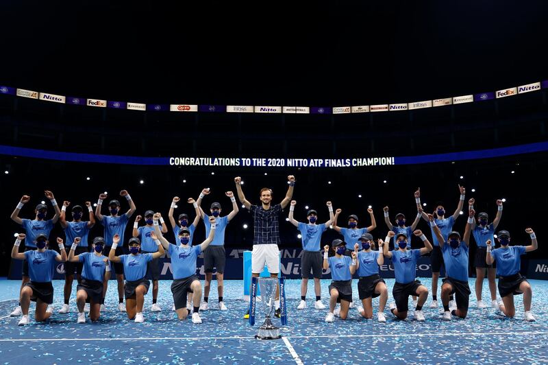 Daniil Medvedev and ball kids throw their arms in the air to celebrate his ATP Finals victory. Getty Images