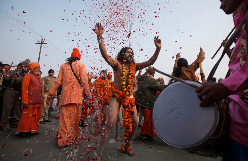 Naga Sadhus, or naked Hindu holy men of the Anand Akhada group, participate in a religious procession towards the Sangam, the confluence of rivers Ganges, Yamuna and mythical Saraswati, as part of the Mahakumbh festival in Allahabad, India, Sunday, Jan. 6, 2013. Millions of Hindu pilgrims are expected to take part in the large religious congregation on the banks of Sangam during the Mahakumbh festival in January 2013, which falls every 12th year. (AP Photo/Rajesh Kumar Singh) *** Local Caption ***  India Kumbh Festival.JPEG-09e23.jpg