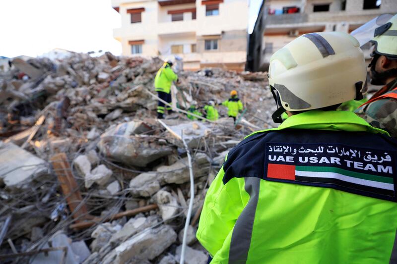 Emirati rescuers sift through the rubble of a collapsed building in the regime-controlled town of Jableh, northwest of the Syrian capital. AFP