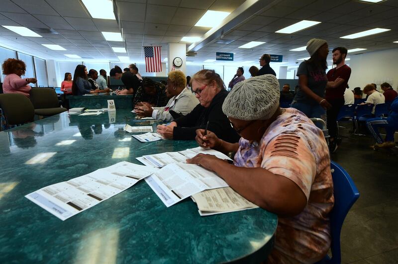 Voters fill out their ballots for early voting at the Los Angeles County Registrar's Office in Norwalk, California. AFP