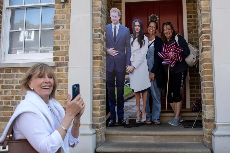 70 Members of the public pose with cardboard cut-outs of Prince Harry and Meghan Markle.  Will Oliver / EPA