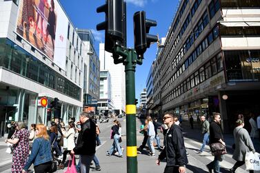  People walk in Drottninggatan during the coronavirus pandemic in central Stockholm, Sweden EPA