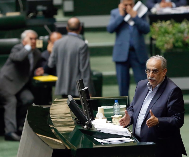 epa06973409 Iranian Economy and Finance Minister Masoud Karbasian (R) speaks to defend himself during an impeachment session at the Iranian Parliament in Tehran, Iran, 26 August 2018. Media reported that parliament sacked Karbasian as Minister of Economy and Finance as Iran is facing an economic crisis. The parliament impeached Economy Minister Masoud Karbasian and on the day voted to sack him.  EPA/ABEDIN TAHERKENAREH