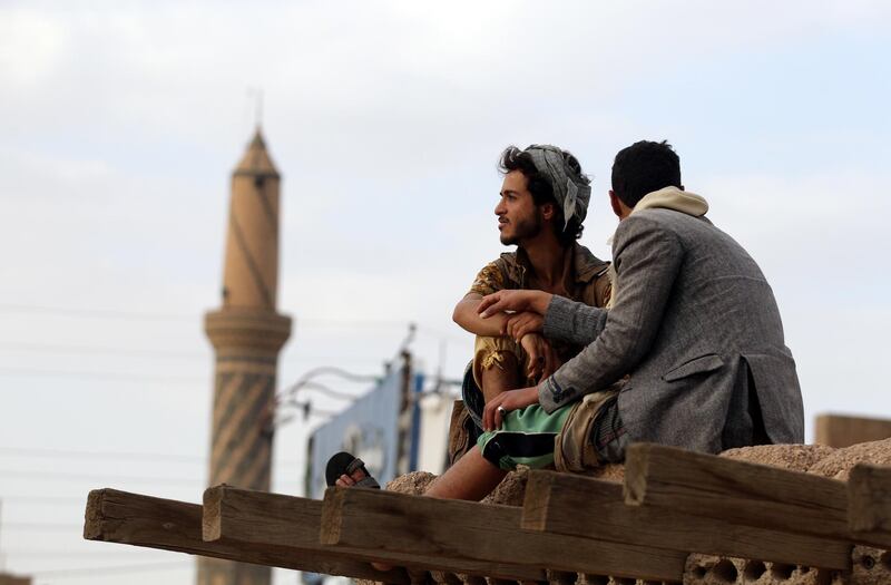 Yemenis wait for iftar sit on the roof of a house near a mosque in Sanaa, Yemen.  EPA