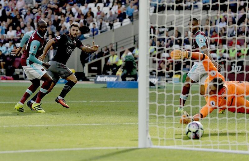 Southampton’s Charlie Austin, second left, scores his side’s first goal against West Ham. Matt Dunham / AP Photo