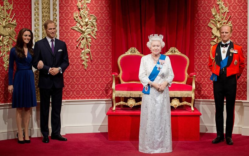 A new waxwork figure of Britain's Queen Elizabeth II (2nd R) is unveiled beside figures of her husband Prince Philip (R) her grandson Prince William (2nd L) and his wife Catherine, Duchess of Cambridge (L) at Madame Tussauds in London, on May 14, 2012.  The Queen's waxwork, replicating the official Jubilee photograph released earlier this year, has been placed centre stage in the Royal Area of the attraction. The figure is dressed in a recreation of the white and silver lace dress covered in 53,000 Swarovski elements with blue silk sash adorned with The Queen���s Garter Badge, topped off by a replica of the diamond and pearl George IV State Diadem. AFP PHOTO / LEON NEAL (Photo by LEON NEAL / AFP)