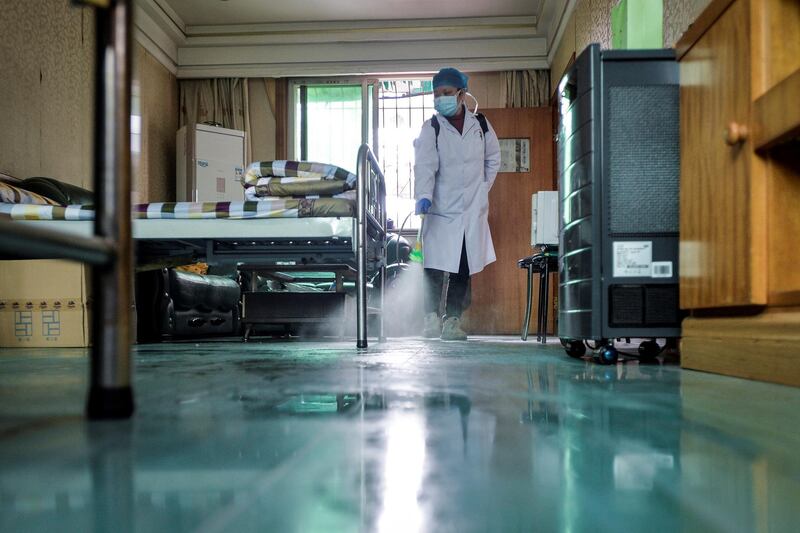 A doctor disinfects a room for medical staff with sanitizing equipment at a community health service center, in Qingshan district of Wuhan, Hubei province, China.  Reuters