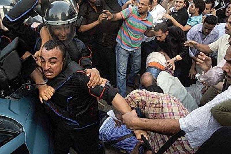 Egyptian opposition supporters clash with police during a demonstration in downtown Cairo against the presidency being hereditary, September 21.