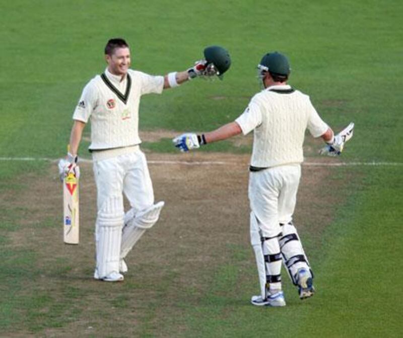 Michael Clarke of Australia celebrates scoring a century with team mate Marcus North during day one of the First Test match between New Zealand and Australia at Westpac Stadium on Friday, March 19, 2010 in Wellington, New Zealand.