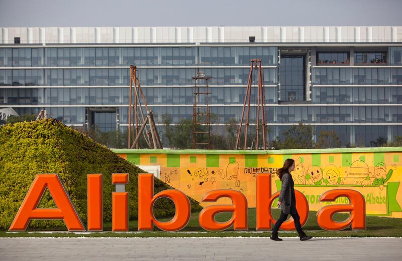 epa06303991 (FILE) - A file photo dated 04 November 2013 showing an employee walking past a logo of Alibaba Group at its base on the outskirts of Hangzhou, Zhejiang province, China. Alibaba Group were to announce their September quarter 2017 results on 02 November 2017.  EPA/JEFF LEE