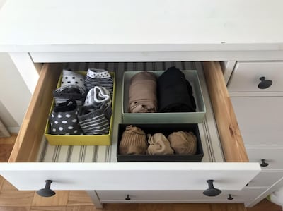 Socks and tights are seen arranged in a drawer in small boxes at a home in Washington, DC, as recommended by Japanese tidying expert Marie Kondo, creator of the "KonMari" method, on January 18, 2019. Marie Kondo is small of stature, but her tidying philosophy has reached stratospheric heights. Her book, "The Life Changing Magic of Tidying Up," has earned a cult following since its publication in the US in 2014 -- but it is the 34-year-old's new Netflix show, "Tidying up with Marie Kondo" that has everyone talking. / AFP / Sara KAMOUNI / TO GO WITH AFP STORY by Sara KAMOUNI, "Japanese tidying guru sparks joy with cluttered Americans"
