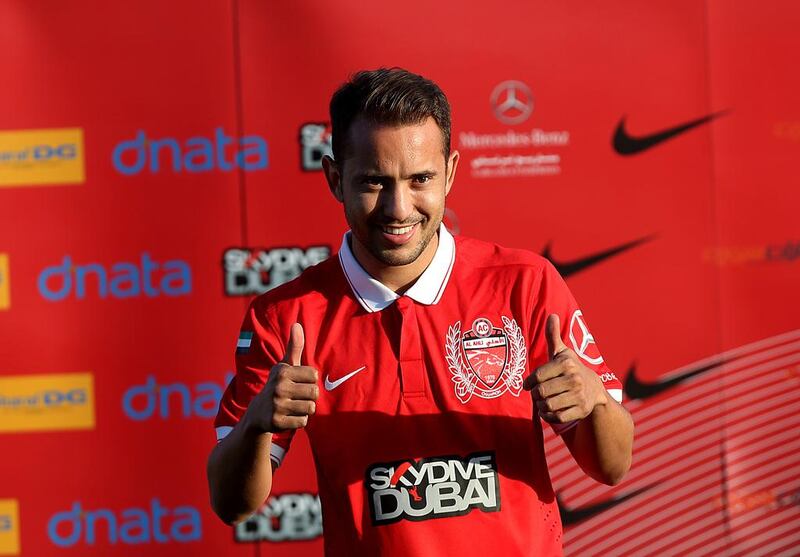 Everton Ribeiro is all smiles as he poses for pictures in his new Al Ahli team jersey. Satish Kumar / The National