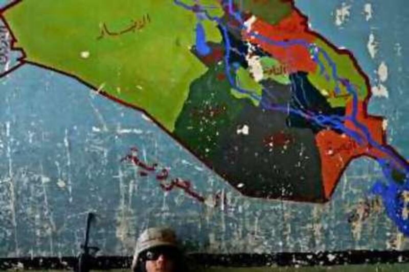 10/14/05 Sadah, Iraq: A Marine sits underneath a mural of a map of Iraq inside a school. Jehad Nga/Corbis

REF rv08AU-Pollack 08/08/08