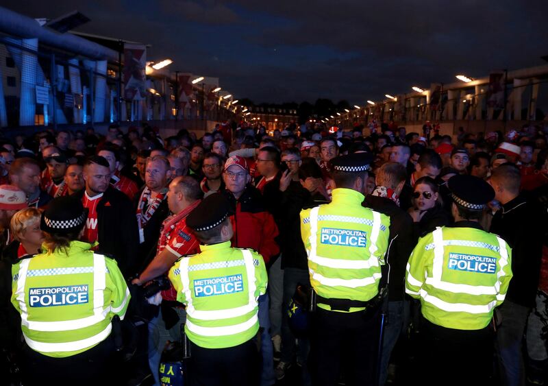 Cologne fans and police outside Emirates Stadium prior to their Europa League match against Arsenal. Nick Potts / AP Photo