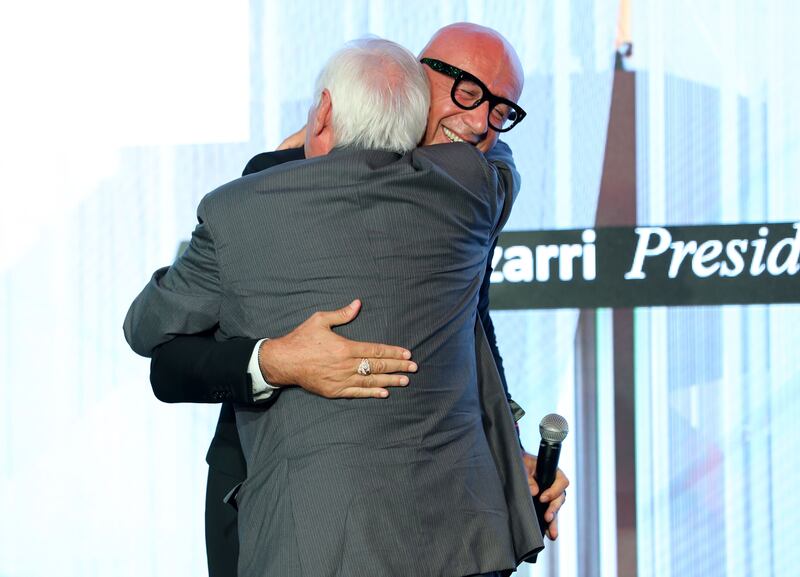 Marco Bizzarri, president of Gucci hugs Alexander Pereira, head of a famous opera house in Florence, after the luxury brand gifted $500,000 toward the opening of a new concert hall.