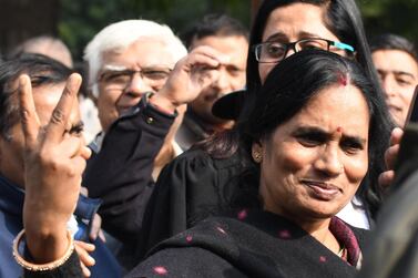 Mother of Delhi fatal bus rape victim shows a victory sign at the Supreme Court in New Delhi, India. EPA