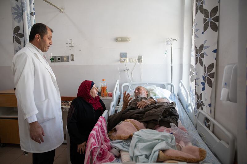 Anwar Baroud, chief nursing officer and hospital supervisor, tends to a patient from Gaza.