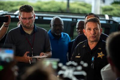 Jacksonville Sheriff Mike Williams, right, holds a news conference, Sunday, Aug. 26, 2018, in Jacksonville, Fla., after a gunman opened fire Sunday during an online video game tournament that was being livestreamed from a Florida mall, killing multiple people and sending many others to hospitals. (AP Photo/Laura Heald)