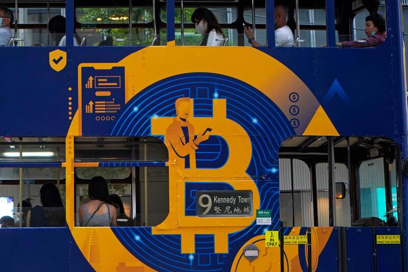 FILE - In this May 12, 2021, file photo, an advertisement of Bitcoin, one of the cryptocurrencies, is displayed on a tram in Hong Kong. Chinaâ€™s biggest banks promised Monday, June 21, 2021, to refuse to help customers trade Bitcoin and other cryptocurrencies after the central bank said executives were told to step up enforcement of a government ban. (AP Photo/Kin Cheung, File)