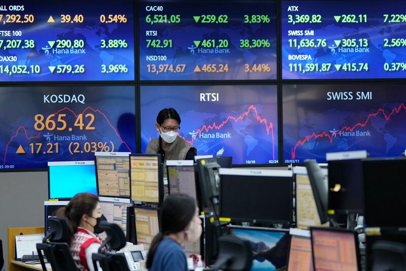 Stock market boards in Seoul. Asian shares rose Friday after US stocks recovered at the end of a wild trading day. AP