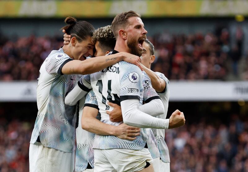 Roberto Firmino celebrates scoring Liverpool's second goal with teammates. Action Images