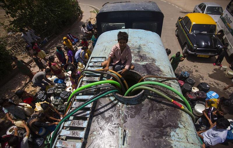 A government water tanker provides New Delhi residents with drinking water. Andrew Caballero-Reynolds / AFP

