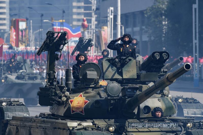 Korean People's Army (KPA) soldiers stand atop armoured vehicles during a military parade on Kim Il Sung square in Pyongyang.  AFP