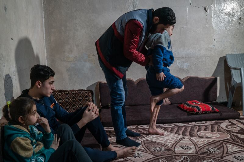 Young patient Mustafa Al Ghanam, whose feet were crushed in the February 6, 2023 quake, performs exercises under guidance of the physio, in Azmarin village, Idlib province. ‘I felt great pain at the beginning after the injury, but I adapted and began to improve with the physical therapy services,’ said Mustafa