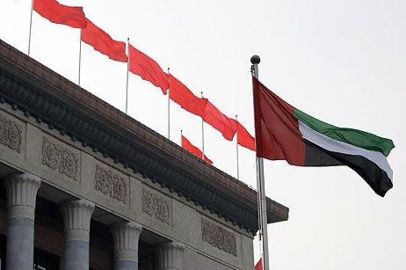 The flag of the United Arab Emirates flies outside the Great Hall of the People in Beijing. Trade between the UAE and China has accelerated at a rapid rate in recent years. Ryan Carter / The National