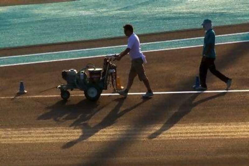 Crews prepare the track for the upcoming Grand Prix at Yas Marina Circuit.