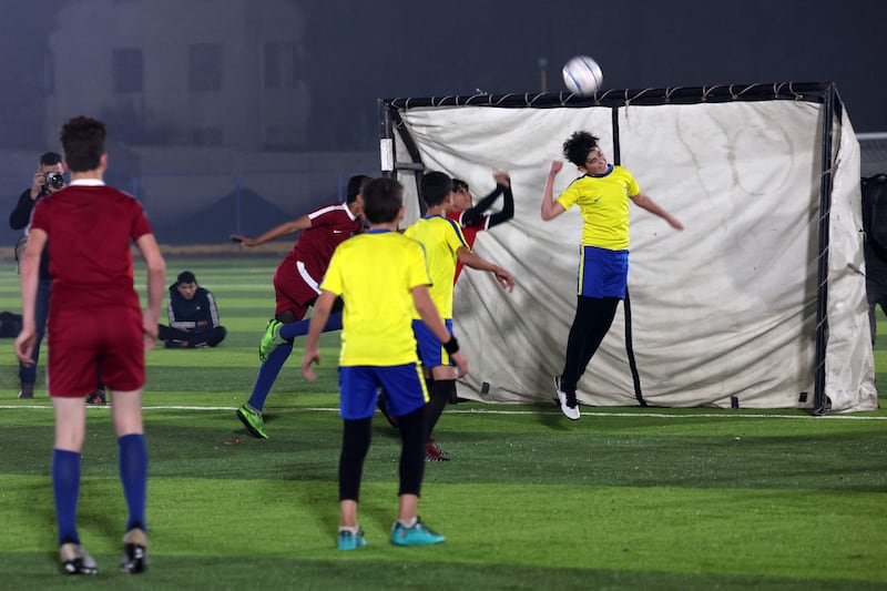 Children representing Qatar and Ecuador in action