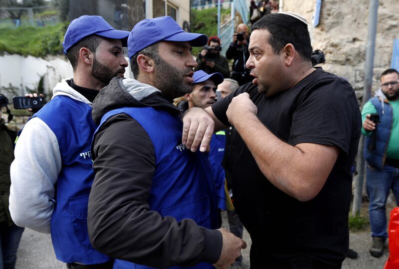 epa07357740 An Israeli settler (R) argues with Palestinians wearing blue vests marking them as 'Oservers' during a protest against the end of the mandate for the civilian Temporary International Presence in Hebron (TIPH) in the West Bank city of Hebron, 10 February 2019. The protest was aimed at marking the removal of the international observers mission from Hebron and anniversary of the so-called Cave of the Patriarchs massacre by Israeli settler Baruch Goldstein on 25 February 1994, that initially led to the establishing of the TIPH.  EPA/ABED AL HASHLAMOUN