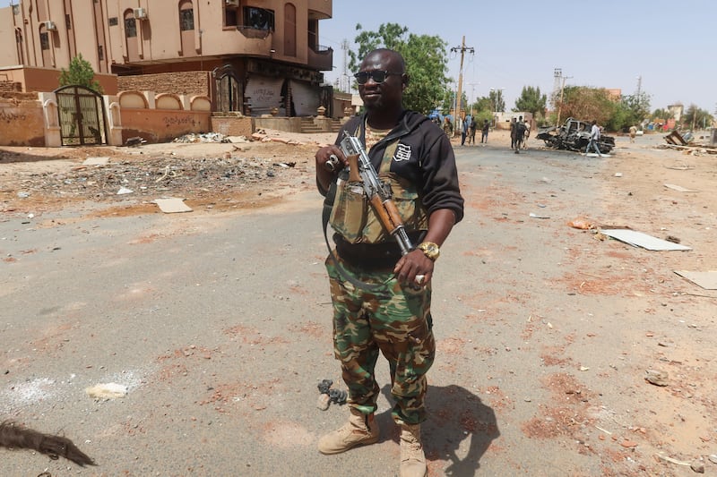 A member of Sudanese Armed Forces holds his weapon in the street in Omdurman, Sudan. Reuters