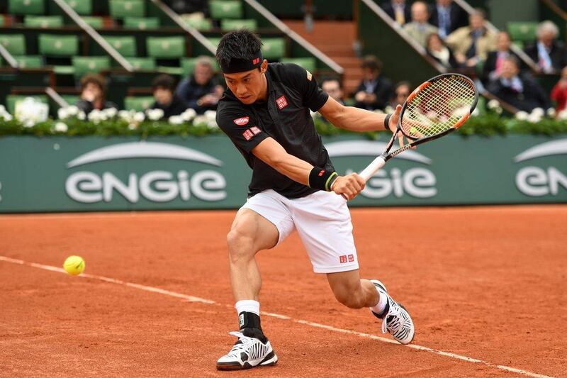 Kei Nishikori of Japan hits a backhand during the Men’s Singles first round match against Simone Bolelli of Italy  on day two of the 2016 French Open at Roland Garros on May 23, 2016 in Paris, France. (Dennis Grombkowski/Getty Images)