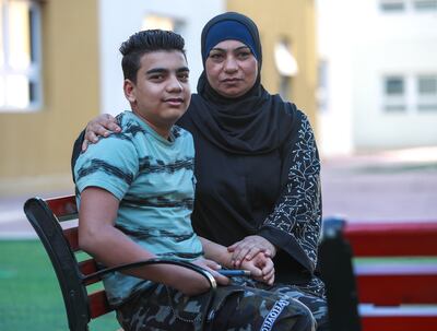 Laila Ibrahim with son Malek, who was fitted with a prosthetic arm at Emirates Humanitarian City. Victor Besa / The National