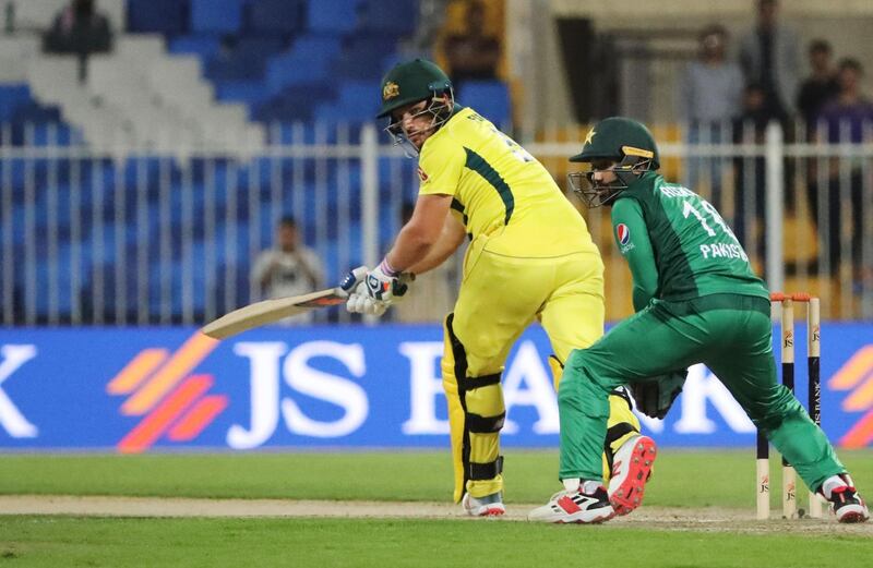 Australian cricketer Aaron Finch (L) plays a shot during the second one day international (ODI) cricket match between Pakistan and Australia in Sharjah, in the United Arab Emirates on March 24, 2019. / AFP / KARIM SAHIB
