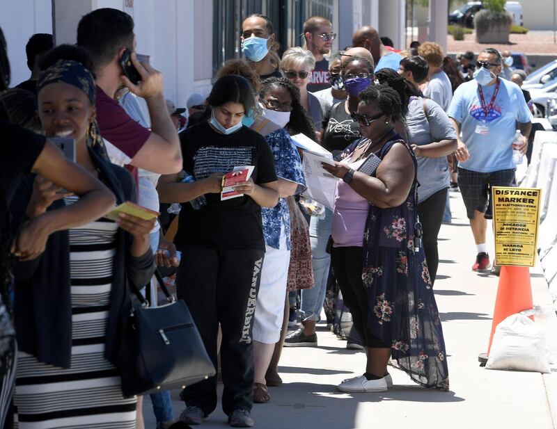 People who are registering to vote or who need a ballot wait in line outside the Clark County election department, which is serving as both a primary election ballot drop-off point and an in-person voting centre amid the coronavirus pandemic in North Las Vegas, Nevada. This is the first time ballots have been mailed to all registered active voters in Nevada's history.  Getty Images