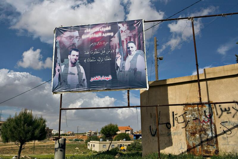 A poster for slain martyrs including drug baron Ali Abbas Jaafar (left) seen in the Hay an Sharawneh neighborhood of Baalbek, just meters from a Lebanese Army checkpoint. April 21, 2010.ÊMitchell Prothero/The National