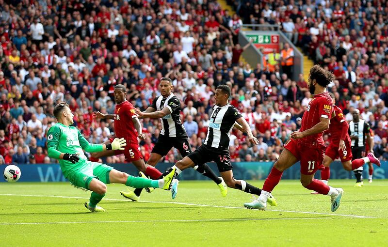 File photo dated 14-09-2019 of Liverpool's Mohamed Salah (right) scores his side's third goal of the game during the Premier League match at Anfield, Liverpool. PA Photo. Issue date: Wednesday March 18, 2020. Sadio Mane had already scored two terrific goals to wipe out Newcastle's early lead through a Jetro Willems thunderbolt when Salah took centre stage. The Egyptian played a one-two with Roberto Firmino - the Brazilian sending the ball back into his path with a brilliant back-heel flick - and raced into the area to beat Martin Dubravka with an ice-cool finish. See PA story SOCCER Premier League Goals. Photo credit should read Nigel French/PA Wire.