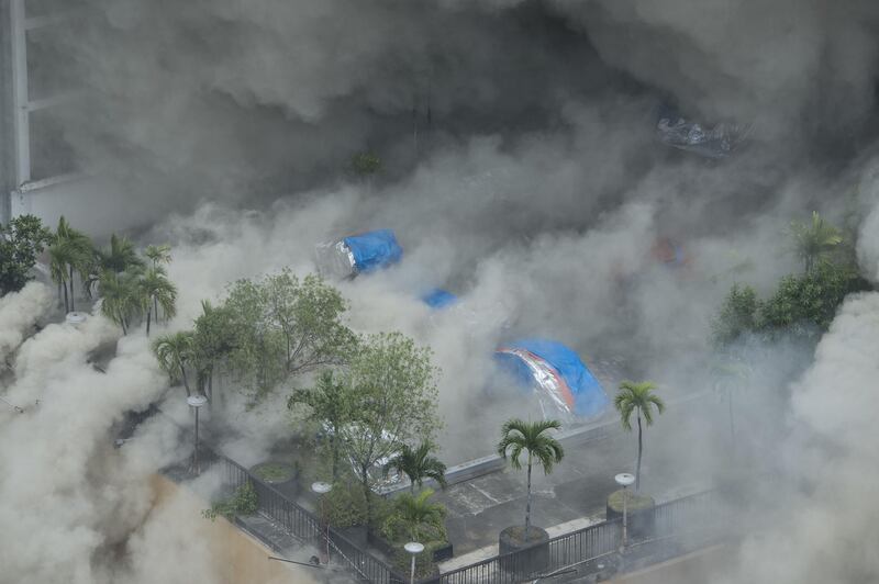 Heavy smoke engulfs the pool side of the Waterfront Manila Pavilion building, a hotel and casino complex, after a fire broke out in Manila on March 18, 2018. Ted Aljibe / AFP