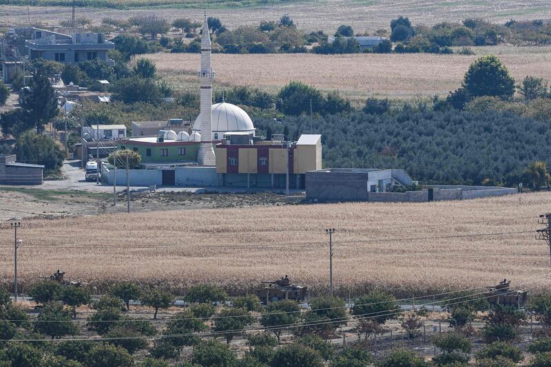 This picture from the Turkish side of the border at Ceylanpinar district in Sanliurfa shows Turkish army armoured vehicles driving near the Syrian town of Ras Al Ain on the first week of Turkey's military operation against Kurdish forces. AFP