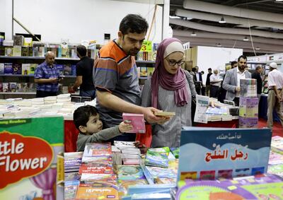 epa07871847 Visitors look at children's books presented at the 19th Amman  International Book Fair, in Amman, Jordan, 26 September 2019. The event opened its doors on 26 September and is due to last until 05 October, featuring publishers from the Arab world with their own books in Arabic and English as well as non-Arabic publications they import. The 19th edition's guest of honor is Tunisia.  EPA-EFE/AMEL PAIN *** Local Caption *** 55498029